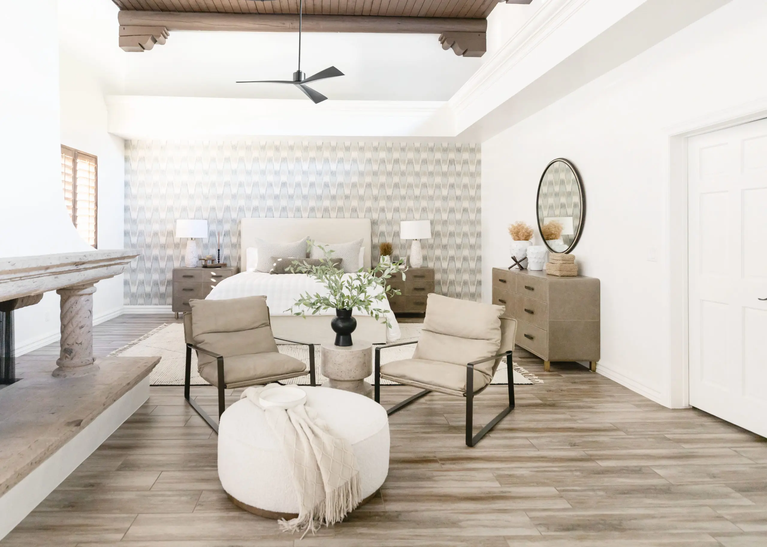 a large bedroom in cream and white with southwestern architecture