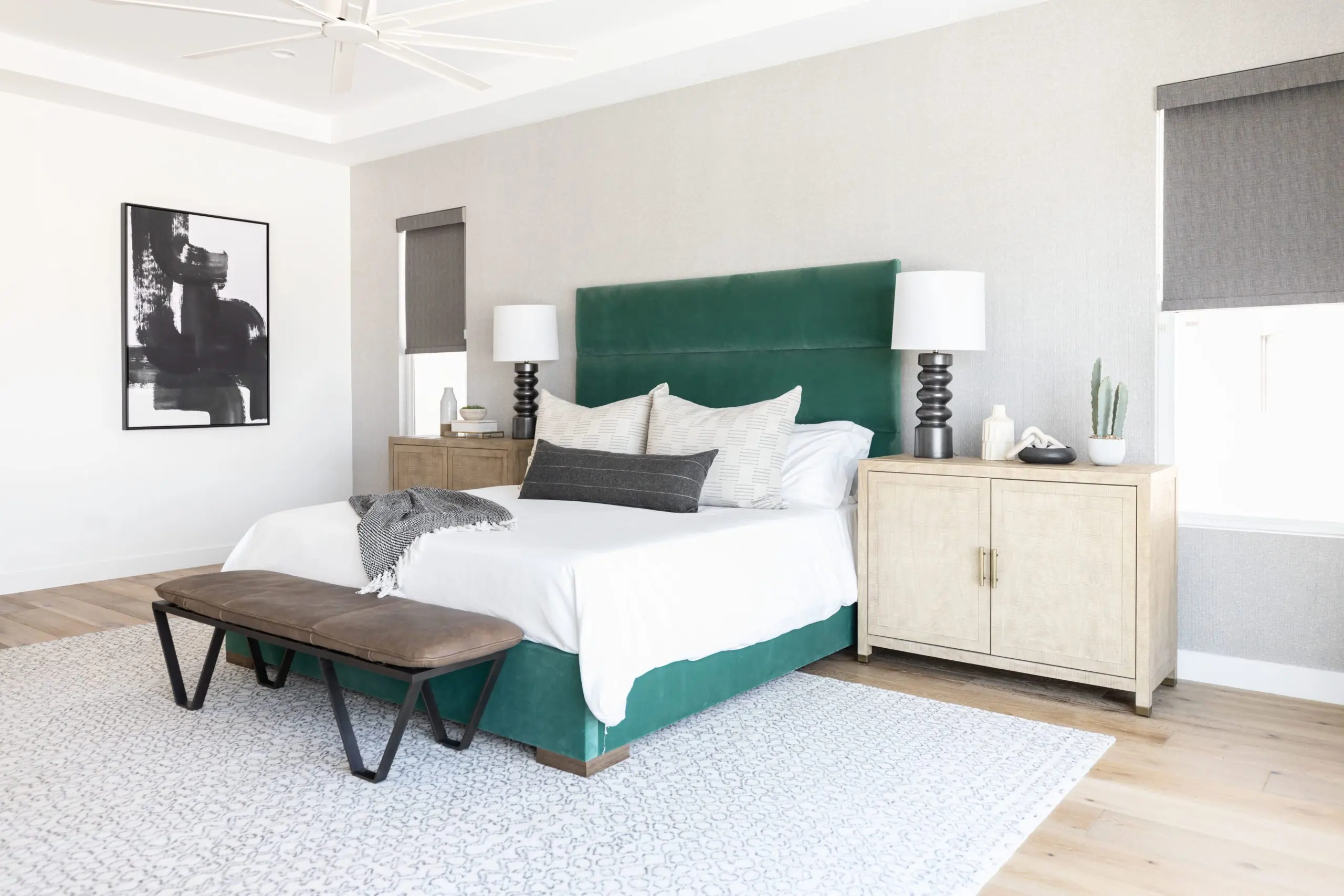 bed with a green velvet headboard and cream bedding
